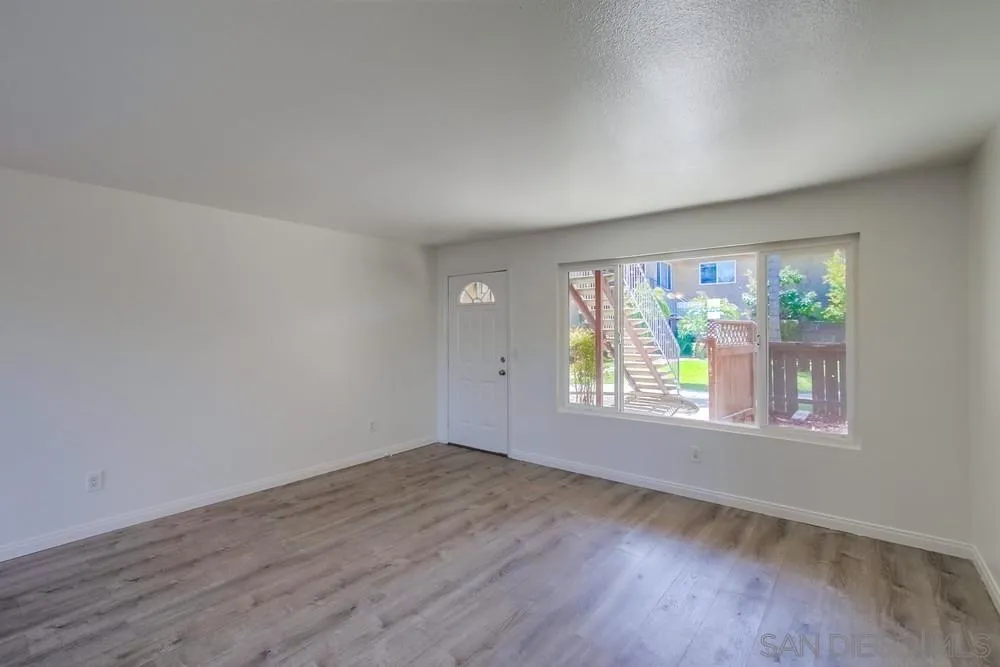 300 Filbert Street, Unit 2 El Cajon, CA 92020 - Photo 11 of 35 an empty room with wooden floor and windows