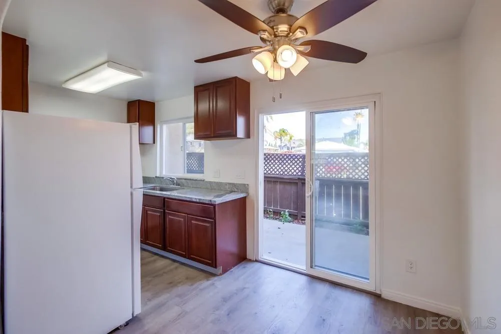 300 Filbert Street, Unit 2 El Cajon, CA 92020 - Photo 12 of 35 a kitchen with granite countertop a stove and a wooden floors