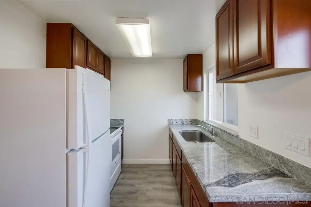 300 Filbert Street, Unit 2 El Cajon, CA 92020 - Photo 15 of 35 a kitchen with granite countertop stainless steel appliances a sink and a refrigerator