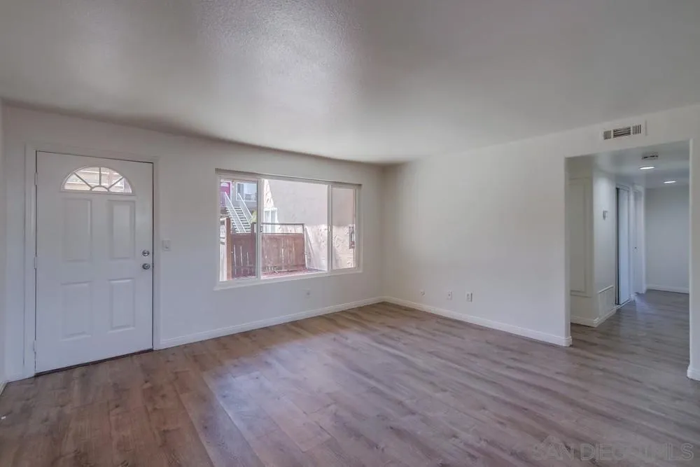 300 Filbert Street, Unit 2 El Cajon, CA 92020 - Photo 10 of 35 an empty room with wooden floor and windows