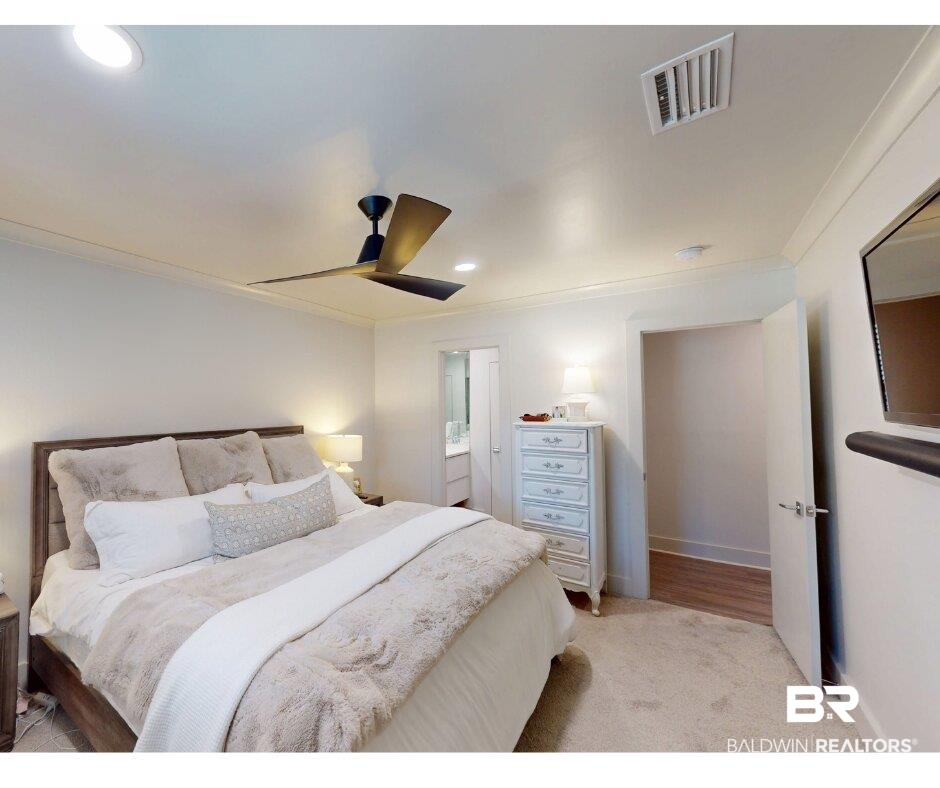 3655 Old Shell Road, Unit 211 Mobile, AL 36608 - Photo 8 of 17 Bedroom with light carpet, ornamental molding, connected bathroom, recessed lighting, and ceiling fan
