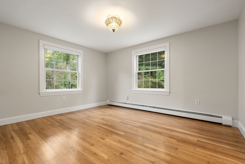92 Abbot Street Andover, MA 01810 - Photo 19 of 35 a view of an empty room with a window and wooden floor