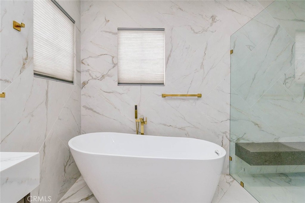 2 Dos Rios Irvine, CA 92602 - Photo 26 of 64 a white bath tub sitting next to a white sink and vanity
