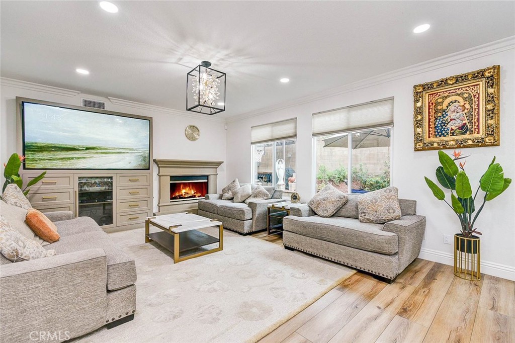 2 Dos Rios Irvine, CA 92602 - Photo 5 of 64 a living room with furniture a fireplace and a flat screen tv