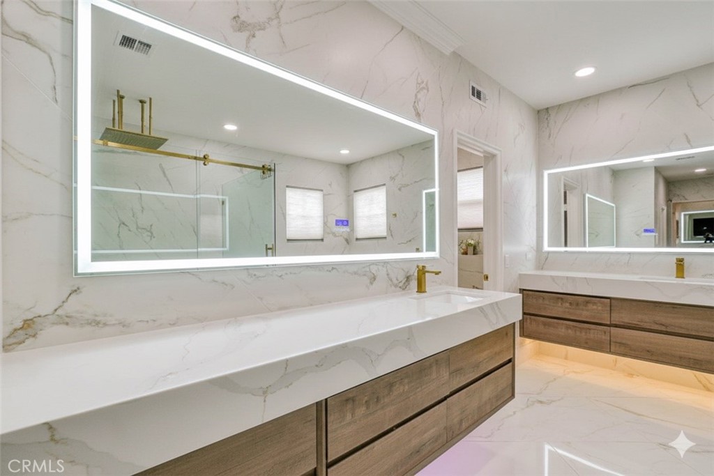 2 Dos Rios Irvine, CA 92602 - Photo 53 of 64 a spacious bathroom with a sink a mirror a bathtub and next to a window