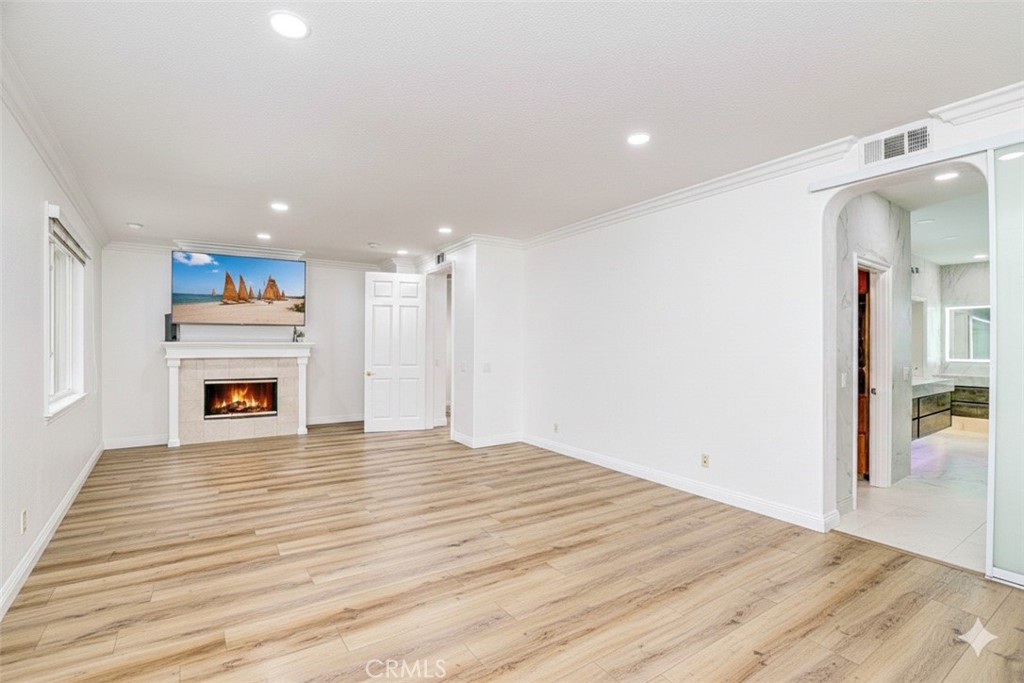 2 Dos Rios Irvine, CA 92602 - Photo 63 of 64 a view of a hallway with wooden floor and a fireplace