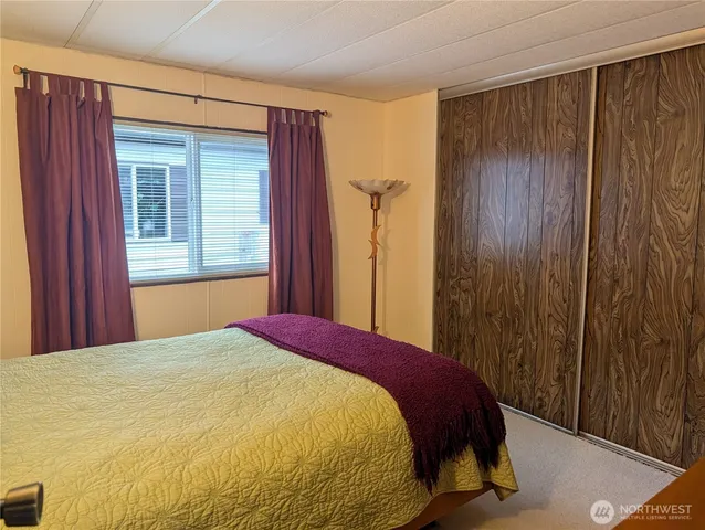 a bed sitting in a bedroom next to a wooden door