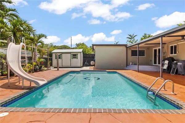 swimming pool view with a outdoor seating