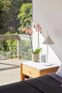 a view of a room with a floor to ceiling window and wooden floor