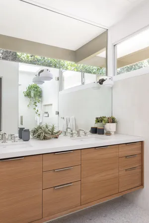 a bathroom with a double vanity sink and a mirror