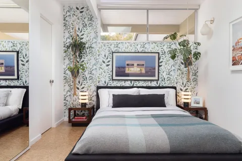 a bedroom with a bed and a couch