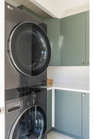 a utility room with a light fixture and a washer dryer