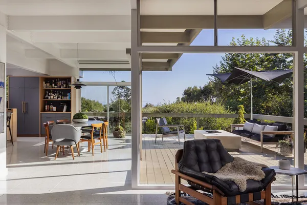 a living room with lots of furniture and a floor to ceiling window