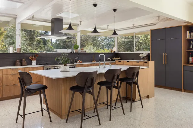 a dining table with chairs and window