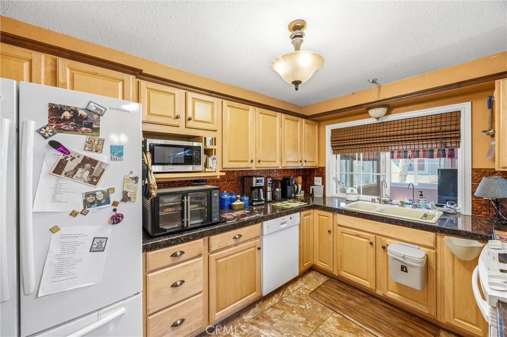 1539 Robyn Street Redlands, CA 92374 - Photo 16 of 47 a kitchen with stainless steel appliances granite countertop a sink and cabinets