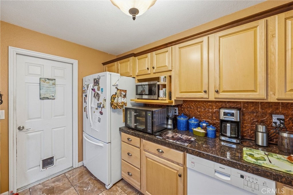1539 Robyn Street Redlands, CA 92374 - Photo 19 of 47 a kitchen with stainless steel appliances granite countertop a refrigerator and sink