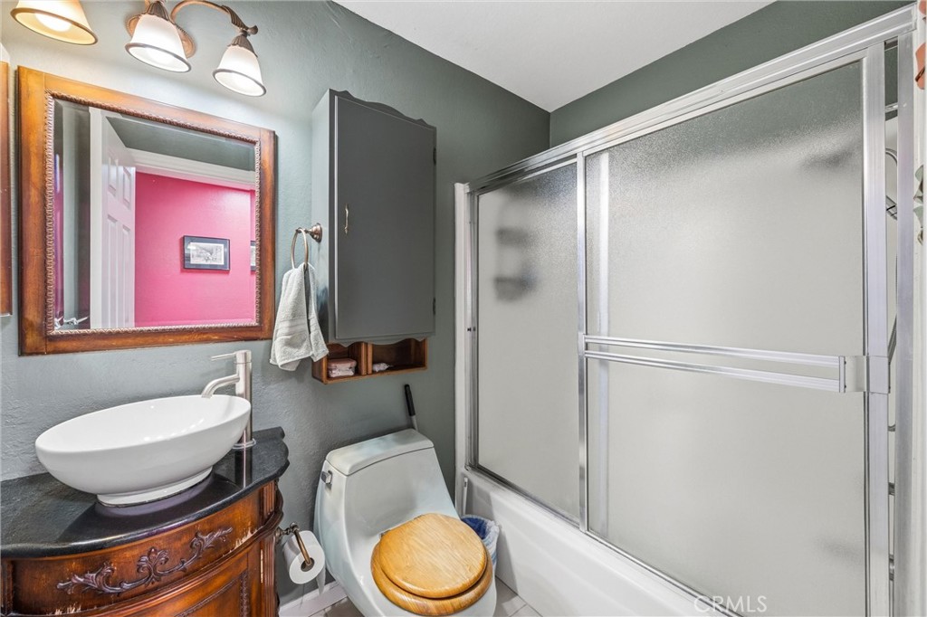 1539 Robyn Street Redlands, CA 92374 - Photo 25 of 47 a bathroom with a granite countertop toilet sink and mirror