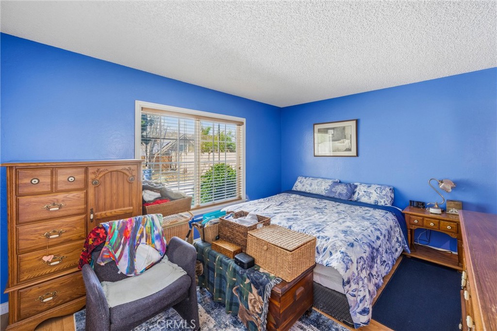 1539 Robyn Street Redlands, CA 92374 - Photo 26 of 47 a bedroom with a bed a dresser and a large window