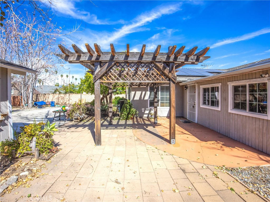 1539 Robyn Street Redlands, CA 92374 - Photo 30 of 47 a view of a patio with a table and chairs and potted plants