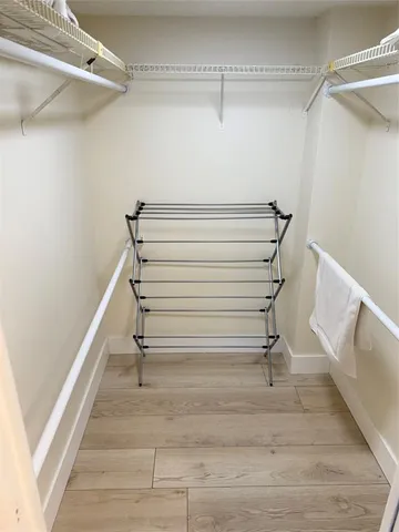 a view of empty room with wooden floor and window