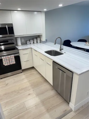 a kitchen with a sink and a stove top oven