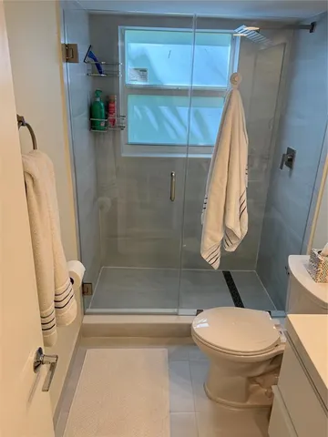 a bathroom with a sink toilet and mirror