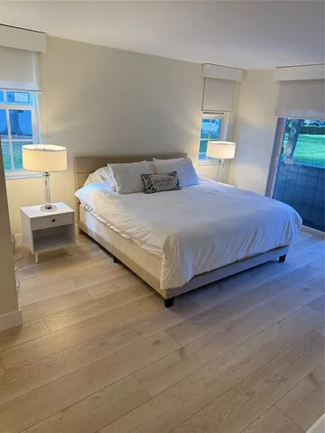 a bedroom with a bed and a lamp