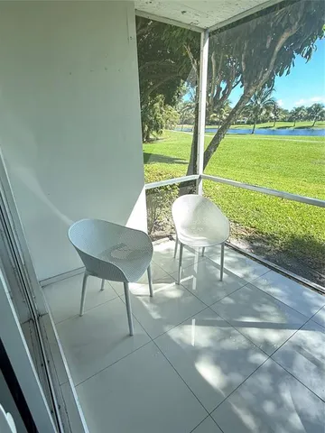 a living room with furniture and a dining table with wooden floor