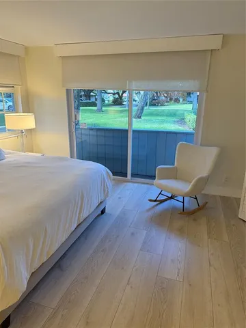 a bed sitting in a bedroom next to a window