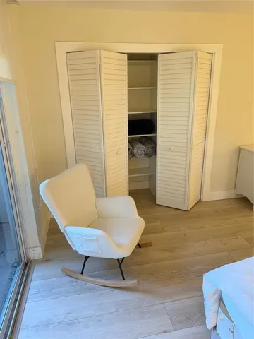 a view of a room with furniture and wooden floor