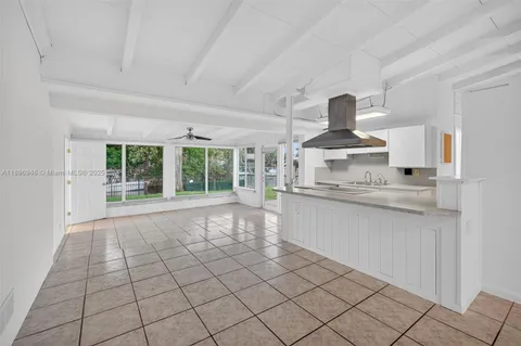 a kitchen with a sink a stove and cabinets