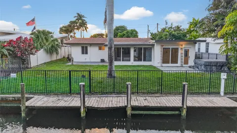 a living room with furniture gym equipment and a large window