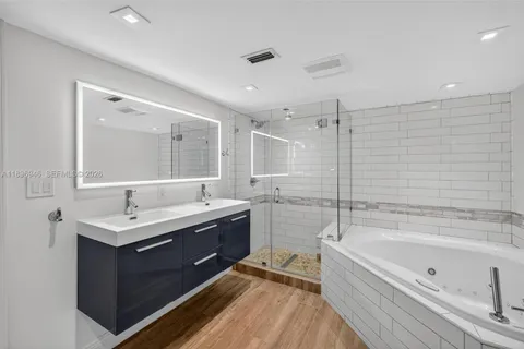 an aerial view of residential houses with outdoor space and trees