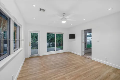 a view of room with window and ceiling fan