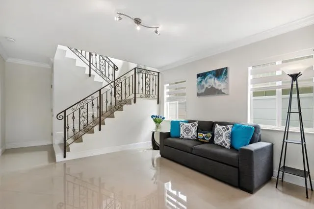 a living room with furniture and stairs