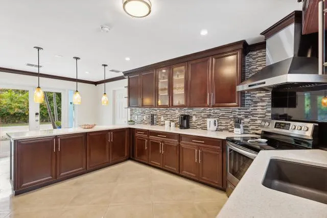 a kitchen with stainless steel appliances granite countertop a sink and stove top oven with granite countertops