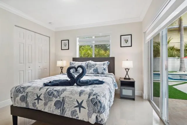 a bedroom with a bed and a night stand