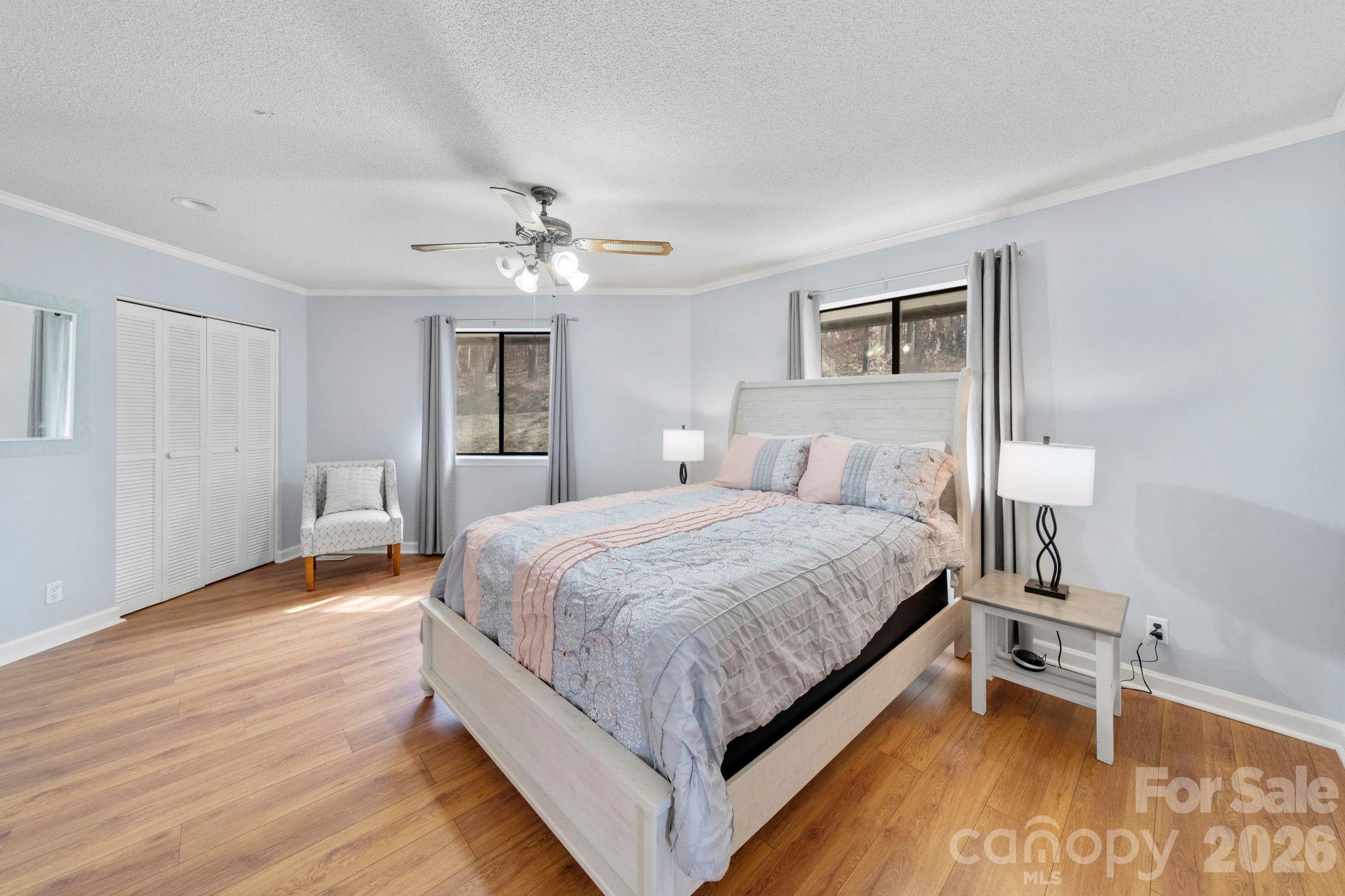 1777 Wild Turkey Road, Unit 23 Camden, SC 29020 - Photo 18 of 45 a spacious bedroom with a bed and a chandelier