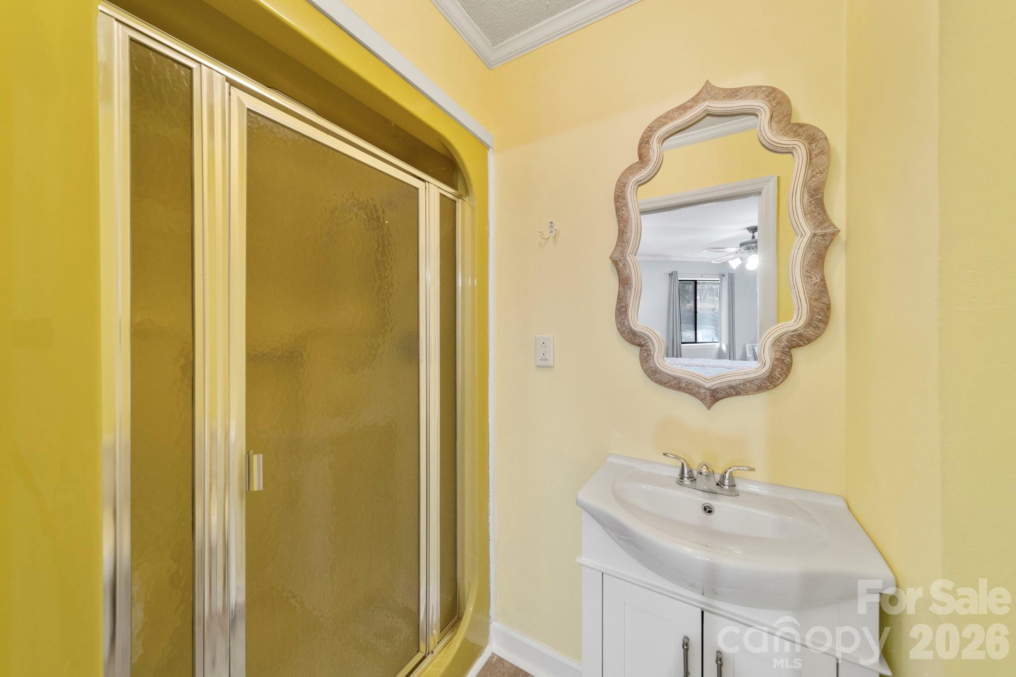 1777 Wild Turkey Road, Unit 23 Camden, SC 29020 - Photo 32 of 45 a bathroom with a sink a mirror and a shower