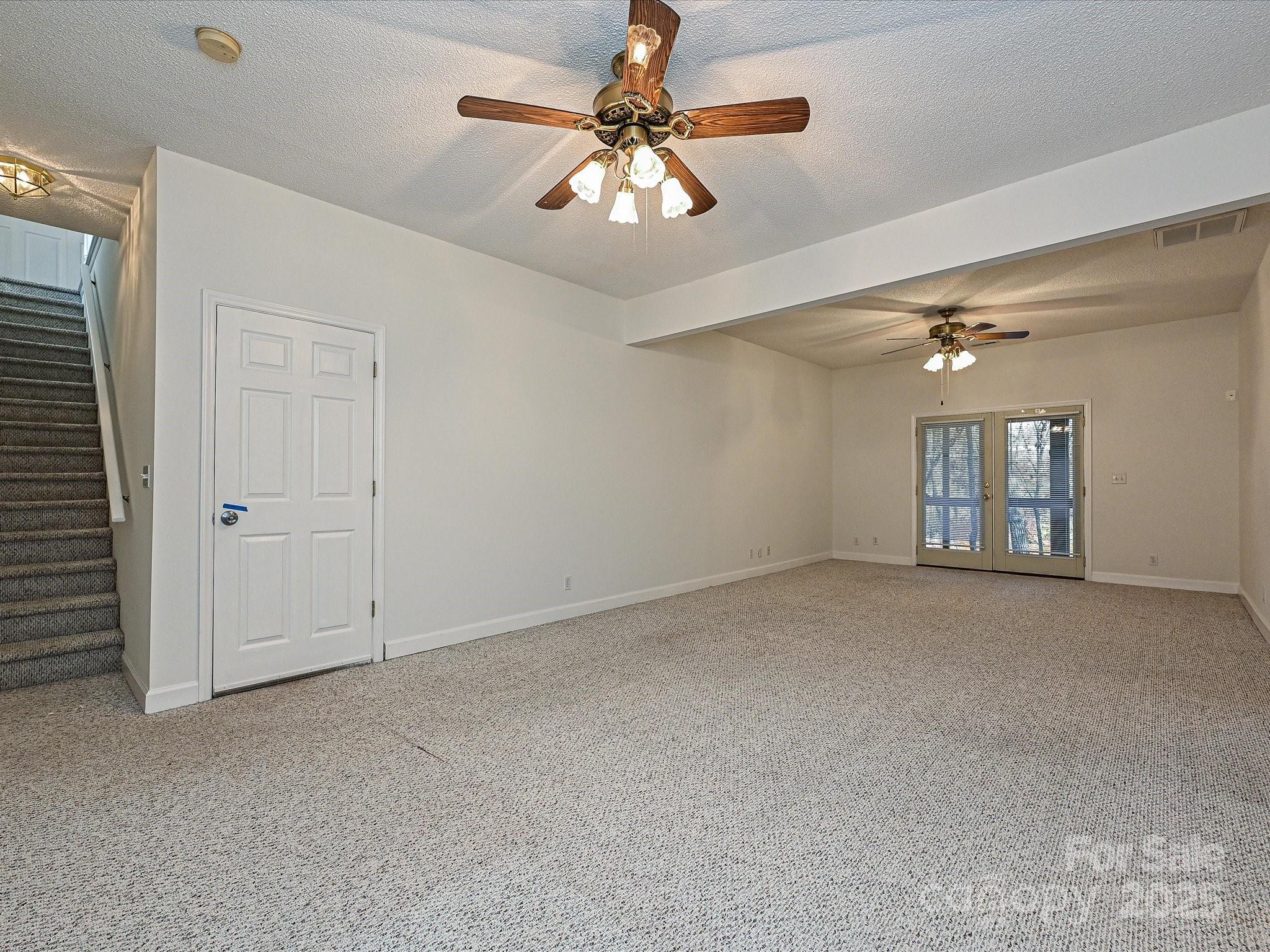 25040 Timberlake Drive Tega Cay, SC 29708 - Photo 29 of 40 a view of a livingroom with a chandelier fan