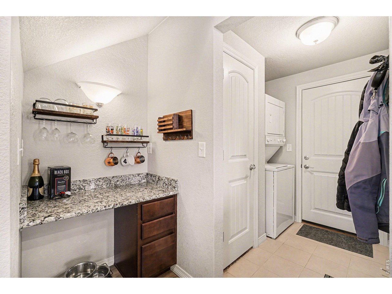 107 South 8th Street Berthoud, CO 80513 - Photo 17 of 22 a bathroom with a granite countertop sink a vanity and shower