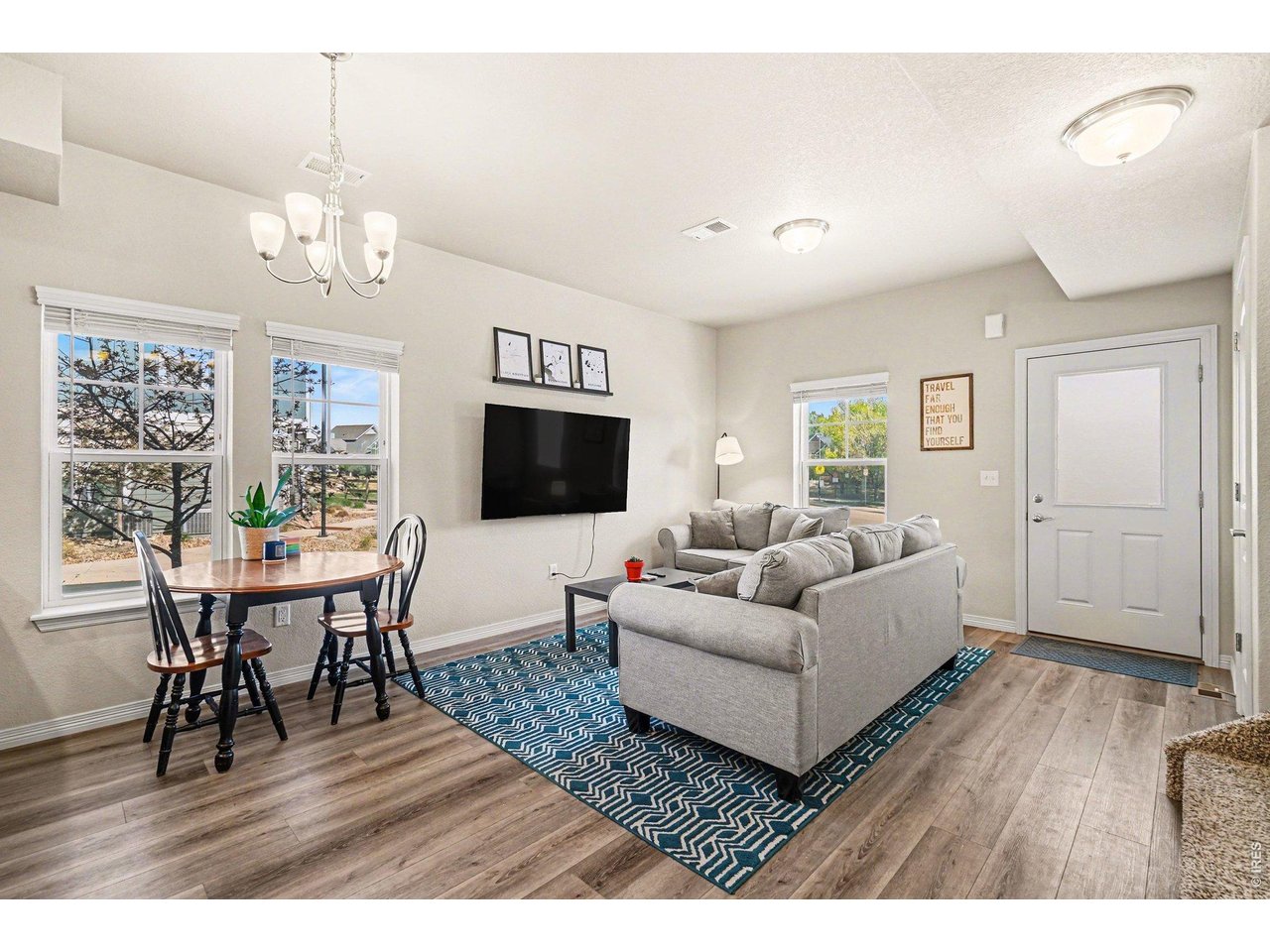 107 South 8th Street Berthoud, CO 80513 - Photo 3 of 22 a living room with furniture dining table and a flat screen tv