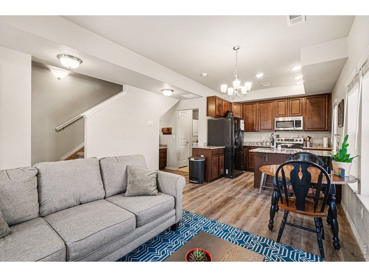 107 South 8th Street Berthoud, CO 80513 - Photo 5 of 22 a living room with furniture kitchen and a chandelier