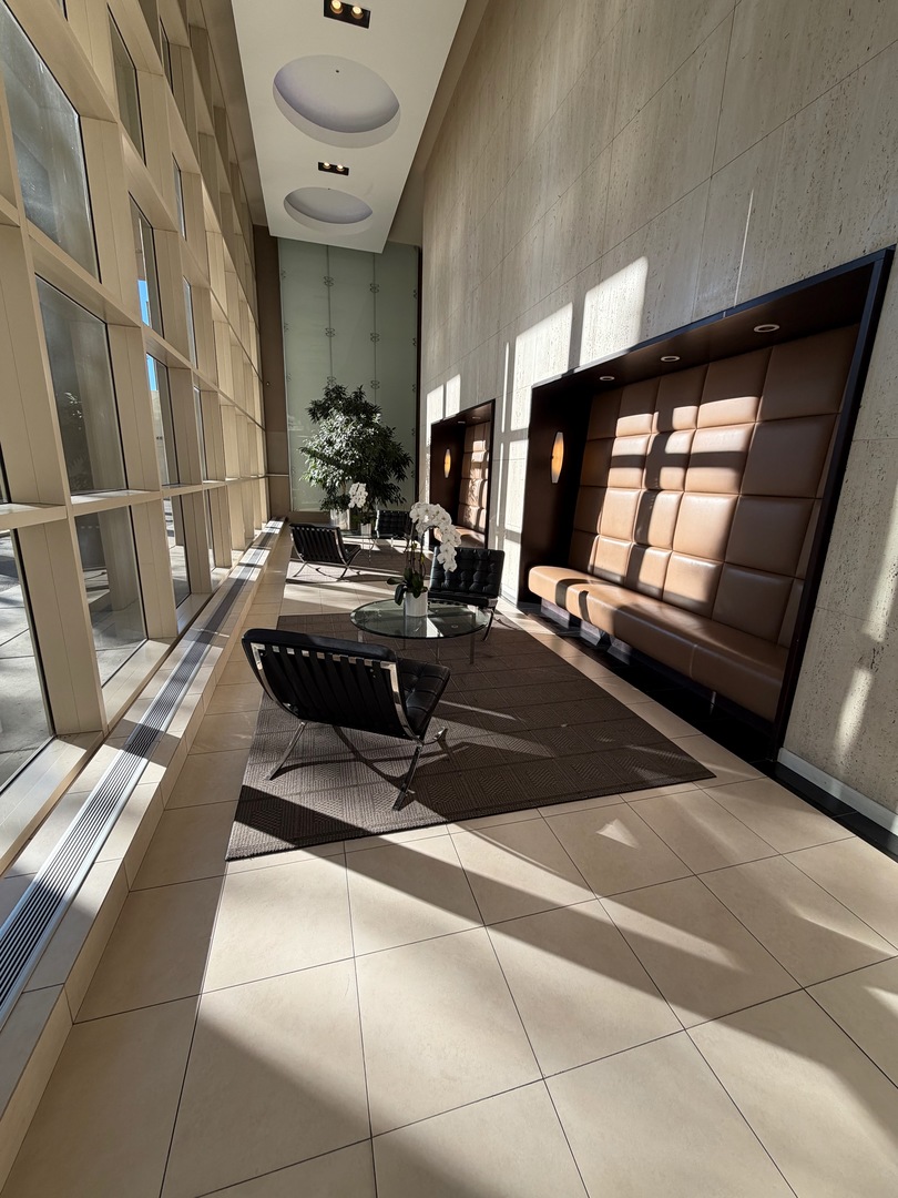 5320 North Sheridan Road, Unit 1407 Chicago, IL 60640 - Photo 4 of 21 a living room with furniture and a fireplace