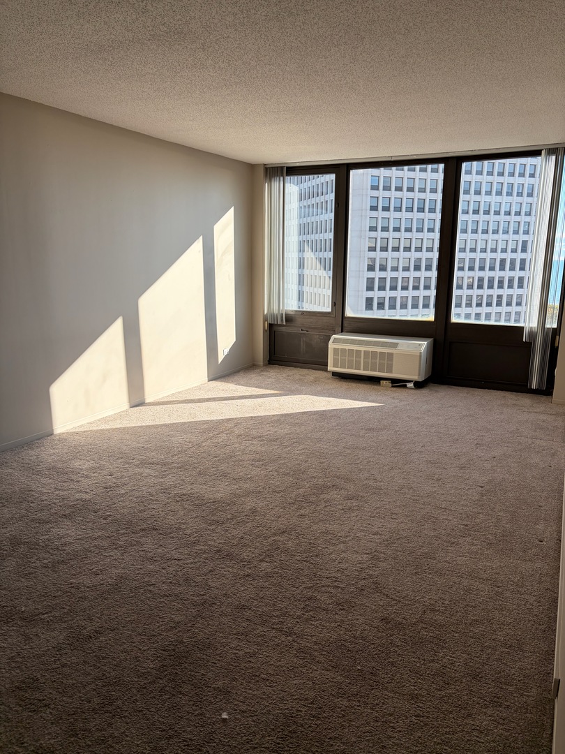 5320 North Sheridan Road, Unit 1407 Chicago, IL 60640 - Photo 7 of 21 a view of an empty room with a window