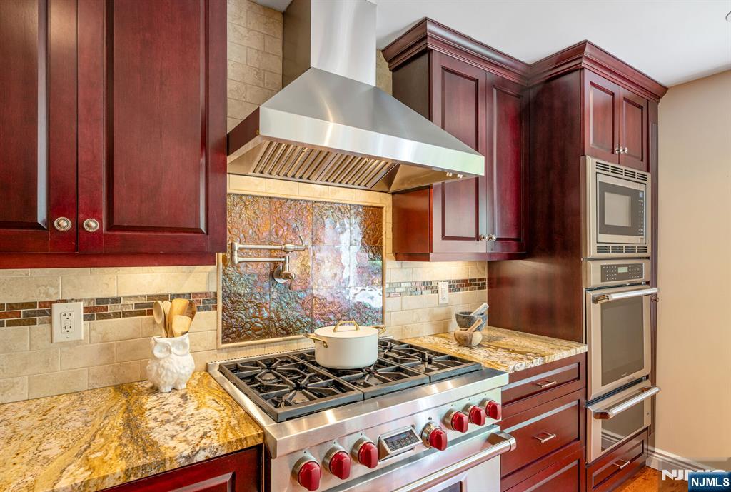 84 Bogerts Mill Road Harrington Park, NJ 07640 - Photo 11 of 47 a kitchen with stainless steel appliances granite countertop a stove and a microwave