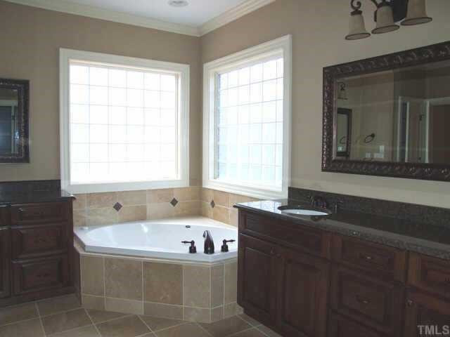 2600 Sunbriar Lane Raleigh, NC 27613 - Photo 7 of 9 Stained cabinetry, custom tile work and granite vanities give the Master Bath a rich feel! Other