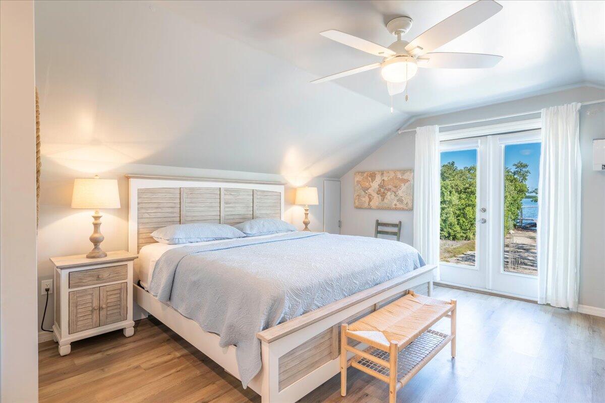 3167 Stewart Road Summerland Key, FL 33042 - Photo 3 of 33 a bedroom with a large bed and a chandelier