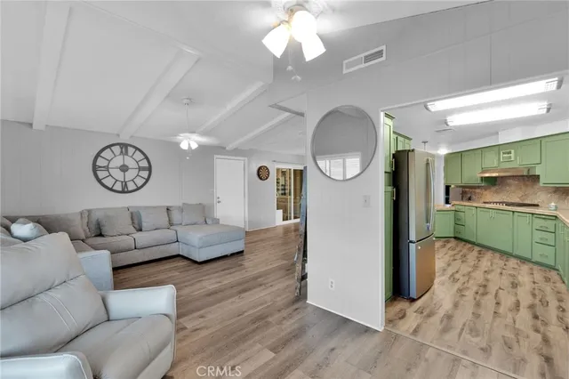a living room with furniture a clock and a window