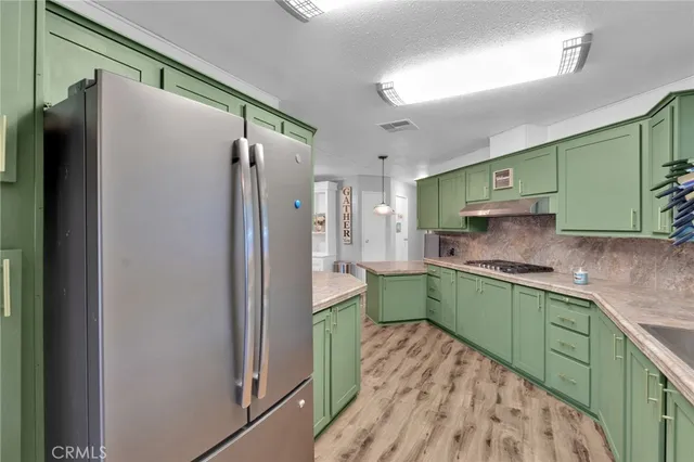 a kitchen with a refrigerator and a sink